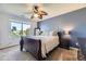 Relaxing bedroom with a large window, leafy ceiling fan, and dark wood furniture at 5327 Suffolk Cir, Castle Rock, CO 80104