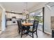 Charming dining area featuring a modern light fixture, table, and sliding doors leading to the outdoor deck at 5327 Suffolk Cir, Castle Rock, CO 80104