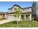 Two-story home with a well-manicured lawn and inviting front porch, enhanced by the young tree at 5327 Suffolk Cir, Castle Rock, CO 80104