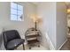 Cozy hallway nook featuring a sleek metal and wood shelf, accent lamp, and comfortable chair at 5327 Suffolk Cir, Castle Rock, CO 80104