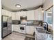 Bright kitchen with white cabinetry, stainless steel appliances, and granite countertops at 5327 Suffolk Cir, Castle Rock, CO 80104
