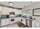 Well-lit kitchen featuring stainless steel appliances, granite countertops, and ample cabinet space at 5327 Suffolk Cir, Castle Rock, CO 80104