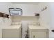 Functional laundry room with side-by-side washer and dryer hookups and overhead storage shelf at 5327 Suffolk Cir, Castle Rock, CO 80104