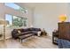 Bright living room with large windows, modern furniture, and wood-look flooring at 5327 Suffolk Cir, Castle Rock, CO 80104