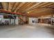 Unfinished basement with open joists, utilities, and storage at 8258 S Sicily Ct, Aurora, CO 80016