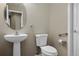 Pedestal sink and toilet with safety bar in half bathroom at 8258 S Sicily Ct, Aurora, CO 80016