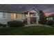 Inviting facade of house with peaked roof, front porch, and lush green lawn at 8258 S Sicily Ct, Aurora, CO 80016