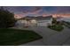 Charming home exterior featuring a well-manicured lawn and attached two-car garage at 8258 S Sicily Ct, Aurora, CO 80016
