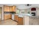 Bright kitchen features wood cabinets, light countertops, and a view to the living room with a fireplace at 8258 S Sicily Ct, Aurora, CO 80016