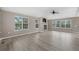 Spacious living room with fireplace, ceiling fan, and windows providing ample natural light at 8258 S Sicily Ct, Aurora, CO 80016