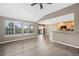 Sunlit living room with adjacent kitchen featuring breakfast bar and access to outdoor living at 8258 S Sicily Ct, Aurora, CO 80016