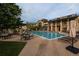 Outdoor pool with lounge chairs, tables, and umbrellas at 8258 S Sicily Ct, Aurora, CO 80016