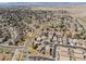An aerial view showcases a neighborhood's layout, with homes and streets spread across a large area at 418 Rifle Ct, Broomfield, CO 80020