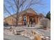 Landscaped backyard featuring a pergola-covered patio, seating area, and attractive rock features at 418 Rifle Ct, Broomfield, CO 80020