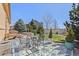 A backyard featuring a patio, comfortable seating, and mature trees providing shade and privacy at 418 Rifle Ct, Broomfield, CO 80020