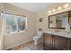 Bathroom with tile flooring, dark wood cabinets, natural light, and decorative wall art at 418 Rifle Ct, Broomfield, CO 80020