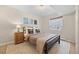 Cozy bedroom features a bed, side table with lamp, and a sunny window with decor at 418 Rifle Ct, Broomfield, CO 80020