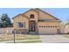 Exterior of a well-kept home featuring a stone facade, a two-car garage, and manicured landscaping at 418 Rifle Ct, Broomfield, CO 80020