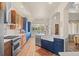 Bright kitchen featuring modern appliances, stylish cabinetry, marble countertops, and a farm-style sink at 418 Rifle Ct, Broomfield, CO 80020