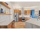 Well-equipped kitchen with wooden cabinetry, stainless steel appliances, and marble countertops at 418 Rifle Ct, Broomfield, CO 80020