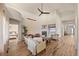 Spacious living room with high ceilings, fireplace, modern ceiling fan, and wood-look floors at 418 Rifle Ct, Broomfield, CO 80020