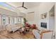 Bright living room featuring fireplace, lots of natural light, and modern ceiling fan at 418 Rifle Ct, Broomfield, CO 80020