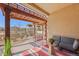 Outdoor patio features wooden pergola, outdoor seating, and garden space with mature landscaping at 418 Rifle Ct, Broomfield, CO 80020