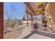 Cozy patio area featuring a pergola, an outdoor dining table and chairs, as well as hanging plants at 418 Rifle Ct, Broomfield, CO 80020