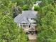 Aerial perspective of a home with a spacious deck, nestled among mature trees for privacy and shade at 18590 Lower Lake Rd, Monument, CO 80132