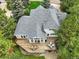 Aerial view of a home showcasing a well-maintained roof and deck surrounded by lush greenery at 18590 Lower Lake Rd, Monument, CO 80132