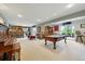 Spacious finished basement with a pool table, piano, and bar area at 18590 Lower Lake Rd, Monument, CO 80132