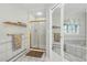 Bright bathroom featuring a shower with gold trim, a soaking tub, and mirrored closet doors at 18590 Lower Lake Rd, Monument, CO 80132