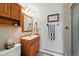A traditional-style bathroom with wood vanity, sink, and shower at 18590 Lower Lake Rd, Monument, CO 80132