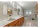 Bathroom with double sinks, tile floor, soaking tub, and ample storage at 18590 Lower Lake Rd, Monument, CO 80132