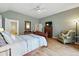 Cozy bedroom featuring hardwood floors, neutral walls and an ensuite bathroom with soaking tub at 18590 Lower Lake Rd, Monument, CO 80132