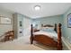 Cozy bedroom with soft carpet, natural light, and a classic wooden bed frame at 18590 Lower Lake Rd, Monument, CO 80132