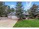Charming two-story home featuring a three-car garage, manicured lawn and mature trees at 18590 Lower Lake Rd, Monument, CO 80132