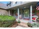 Inviting front porch adorned with patriotic decor, flowers, and comfortable seating at 18590 Lower Lake Rd, Monument, CO 80132