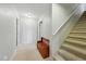Hallway with carpeted stairs and a storage bench, and a closet at 18590 Lower Lake Rd, Monument, CO 80132