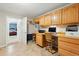 Bright home office area with light wood cabinets, tiled floor, and desk area with a view to a bedroom at 18590 Lower Lake Rd, Monument, CO 80132