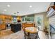 Open kitchen with island, tiled floors, countertops, wood cabinets, and stainless steel appliances at 18590 Lower Lake Rd, Monument, CO 80132