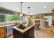 Bright and airy kitchen featuring tile floors, stainless steel appliances, and stone fireplace at 18590 Lower Lake Rd, Monument, CO 80132