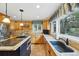 Well-appointed kitchen with granite countertops, custom cabinets, and a breakfast bar at 18590 Lower Lake Rd, Monument, CO 80132