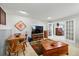 Open-concept living room with dining table, large TV, and charming decor at 18590 Lower Lake Rd, Monument, CO 80132
