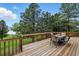 Relaxing wooden deck featuring an outdoor dining set with scenic views of the yard at 18590 Lower Lake Rd, Monument, CO 80132