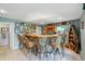 Stylish wet bar with copper accents, bar stool seating, and decorative nautical decor at 18590 Lower Lake Rd, Monument, CO 80132