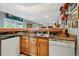 A view of the wet bar area with warm wood cabinets and marble countertops at 18590 Lower Lake Rd, Monument, CO 80132