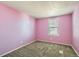 Serene bedroom with plush carpeting, a window for natural light, and a calming pink color scheme at 2885 E Midway Blvd # 1542, Denver, CO 80234