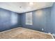 Cozy bedroom with soft carpeting, a window for natural light, and a soothing blue color scheme at 2885 E Midway Blvd # 1542, Denver, CO 80234