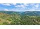 Beautiful aerial view overlooking mountains, blue sky, and scattered homes, offering a serene escape at 10390 Hondah Dr, Littleton, CO 80127